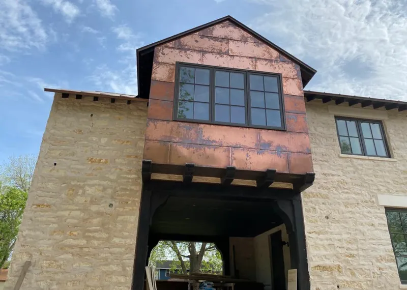 Copper metal panel facade on a stone building for Skylight Installation in East Rutherford