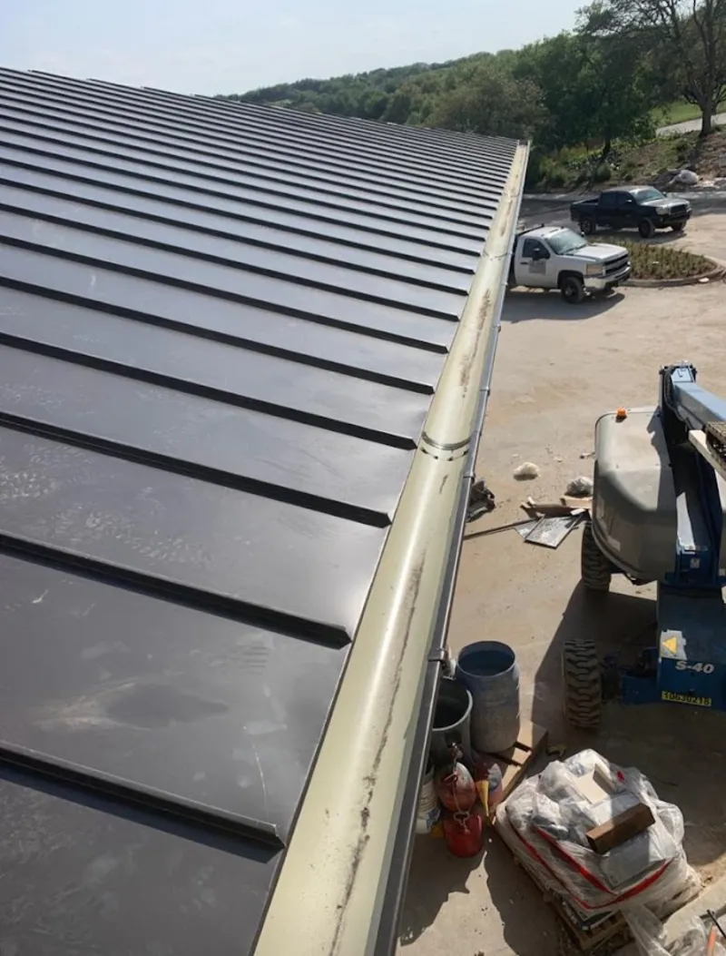 Standing seam panel and gutter detail on a metal roofing jobsite in East Rutherford